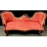 A Victorian mahogany child?s chaise, double arched back, serpentine seat, French cabriole