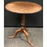 A George III tripod table, fixed top, urn column, 68cm high , 60cm diameter