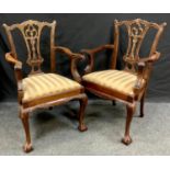 A pair of reproduction Hepplewhite style carver chairs, shaped top rail, pierced vascular splats,