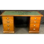 An early 20th century mahogany pedestal desk, rectangular leather inlaid top, kneehole flanked by