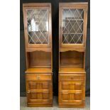 A pair of Priory cabinets, lead glazed cupboard open recess, projecting base, single drawer open