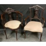 A late Victorian carved mahogany corner chair; conforming open arm elbow chair