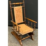 A late 19th/early 20th century oak Childs American rocker, 73cm high.