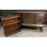 A 20th century oak sideboard, rectangular top above a two short carved drawers and a pair of