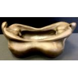 Contemporary School, a bronzed bowl, of two stylised ladies, 34cm wide