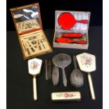 A silver backed dressing table set comprising brush, comb, hand mirror and hand brush; another two