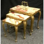 A nest of three onyx and gilt brass tables; an onyx miniature balance scale