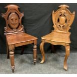 A Victorian oak carved hall chair, shield back, shaped seat, 90cm high; another Victorian mahogany