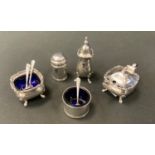 A silver cruet set comprising three mustards, two pepperettes and four mustard spoons; Birmingham
