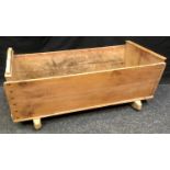 A Victorian pine cot. 44cm high x 94cm long x 44cm wide.