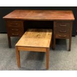 A 20th century oak knee hole desk, rounded rectangular top above sliding trays and five drawers,