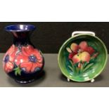 A Moorcroft Crocus pattern circular pin dish, 11.5cm diameter; an Anemone pattern vase, 13cm