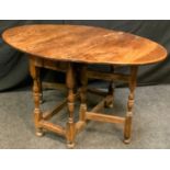 A George III oak gateleg table, oval top, turned legs, 69cm high, 88cm long.