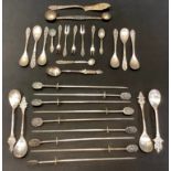 A set of nine silver coloured metal Skewers, mask head terminals, 18.5cm long, unmarked; an