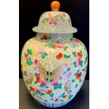 A large contemporary Chinese temple jar and cover decorated with butterflies and flowers. 44.5cm