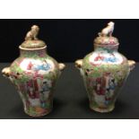 A pair of Cantonese Famille rose miniature jars and covers decorated with figural and floral panels,