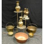 A Victorian two handled brass and copper pan; two jam pans; two saucepan; a three tier bass