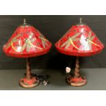 A pair of contemporary Tiffany style lamp shades, with dragonflies on a red ground, 38cm diam