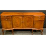 A reproduction mahogany sideboard, inverted breakfront crossbanded top above a pair of cupboard