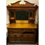 A late Victorian mahogany mirror back sideboard, swan neck pediment, turned columns, central