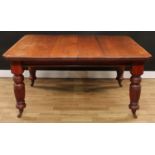 A late Victorian extending dining table, chamfered rectangular top with two additional leaves,
