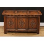 A 17th century style oak blanket chest, hinged top above a three panel front, nulled frieze, each