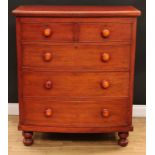 A Victorian pine and mahogany bow front chest of two short over three long cockbeaded drawers,