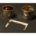 A silver penknife, Sheffield 1955; a pair of large Continental silver napkin rings, marked 800 (3)
