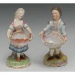 A pair of Sampson Hancock Derby figures, standing in 18th century dress, each holding over size