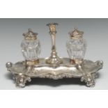 A Victorian Rococo Revival silver shaped rectangular partner's standish, the central taperstick
