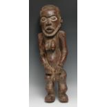 Tribal Art - an African figure, hermaphroditic physiology, the eyes picked out with white pigment,