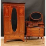 An Edwardian mahogany bedroom suite, comprising wardrobe, 195.5cm high, 113.5cm wide, 49cm deep,