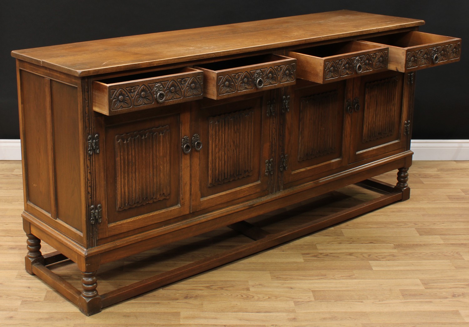 An Old Charm oak low dresser, rectangular top above four frieze drawers and two pairs of linenfold - Image 4 of 4