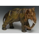A large Continental model, possibly Royal Dux, of an African elephant, in burnished gilt and