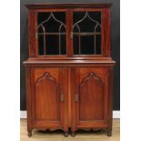 An unusual and composed mahogany library side cabinet, outswept meandrous cornice above a pair of