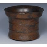 A 17th century bronze mortar, slightly flared rim above two girdles, 14.5cm diam, c.1600-1650