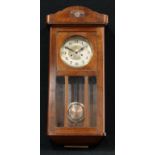 An oak chiming wall clock, Arabic numerals, twin winding holes, pendulum and key, 78cm