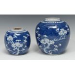 A Chinese ovoid ginger jar, painted in tones of underglaze blue with blossoming prunus on a ground