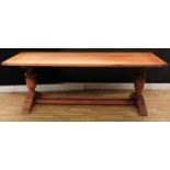 A substantial oak refectory type trestle dining table, rectangular top, boldly turned columns,