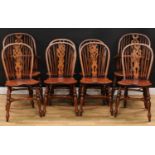 A set of eight Windsor dining chairs, comprising a pair of carver elbow chairs and six side