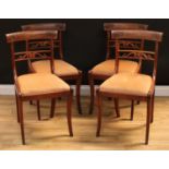 A set of four Regency rosewood dining chairs, by W Huxley, stamped, curved cresting rails carved
