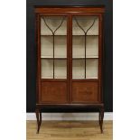 An early 20th century mahogany and marquetry display cabinet, moulded cornice above a pair of