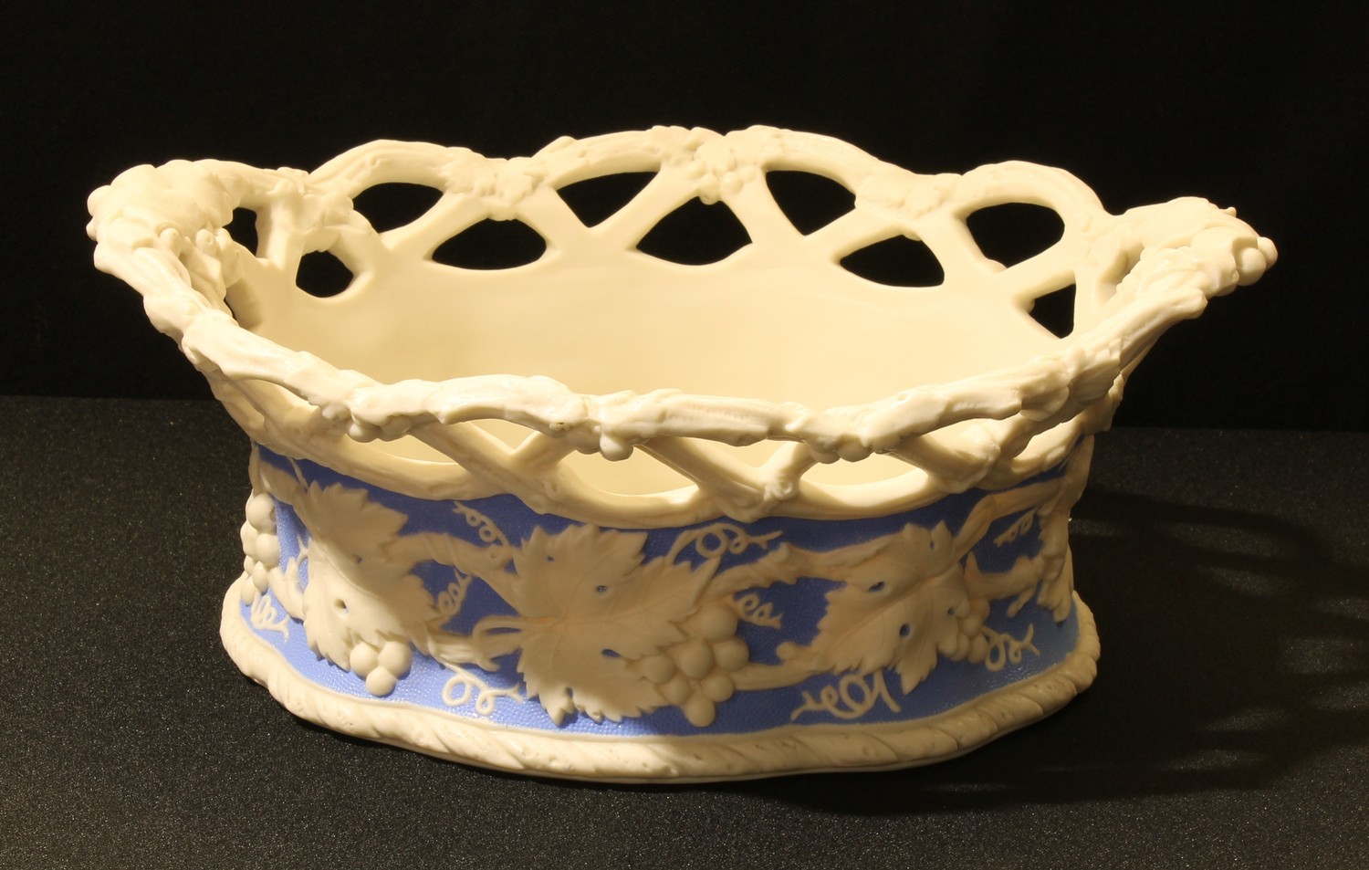 A 19th century Parian Ware basket, moulded with fruiting vine, open work trellis border, 26cm