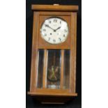 A French oak wall Vedette clock, Arabic numerals, twin winding holes, pendulum and key, 67cm