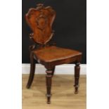 A Victorian oak hall chair, cartouche shaped back, moulded serpentine seat, lotus capped tapered