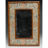 A Chinese rectangular looking glass, the mirror plate with fretwork brackets to angles, the broad