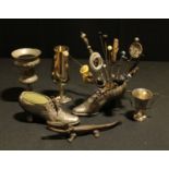 A Renaissance Revival pewter goblet, touchmark to rim; a novelty pin cushion, as a shoe; another;