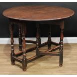 An 18th century oak gateleg table, near-circular top with fall leaves, turned and blocked