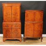 A walnut drinks cabinet, moulded cornice above a pair of cupboard doors enclosing a stepped