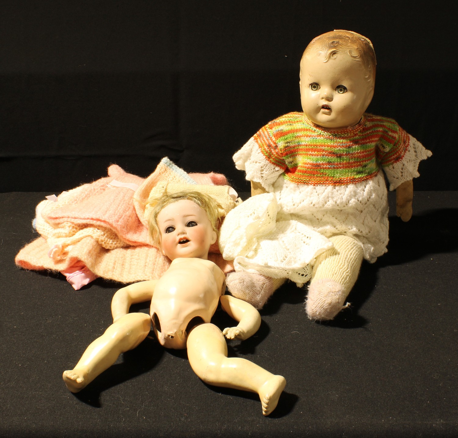 A Heubach and Koppelsdorf bisque head doll, composite body, needs re-stringing; a celluloid doll (2)